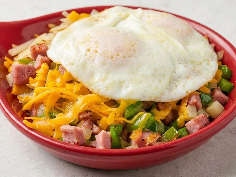 Roman Skillet — ham, green peppers, and onions over hash browns with melted cheese and two eggs